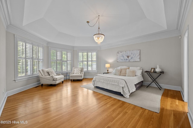 103 Low Country Ct, Hampstead, NC 28443 - bedroom with a raised ceiling, light wood-style flooring, crown molding, and baseboards