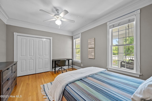 103 Low Country Ct, Hampstead, NC 28443 - bedroom featuring a closet, light wood-style floors, ornamental molding, and a ceiling fan