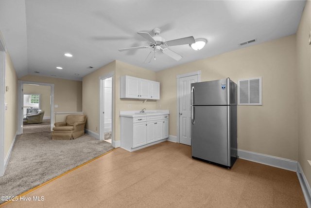103 Low Country Ct, Hampstead, NC 28443 - kitchen featuring freestanding refrigerator, ceiling fan, baseboards, white cabinetry, and recessed lighting