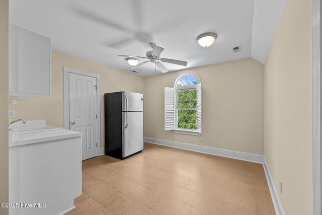 103 Low Country Ct, Hampstead, NC 28443 - kitchen with freestanding refrigerator, light flooring, a ceiling fan, and baseboards