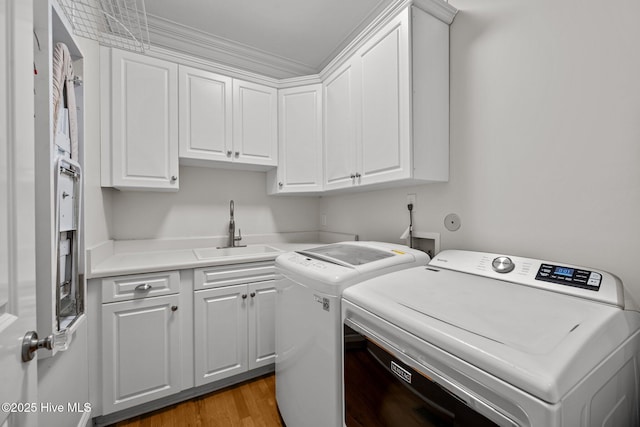 103 Low Country Ct, Hampstead, NC 28443 - laundry room with separate washer and dryer, cabinet space, and light wood finished floors