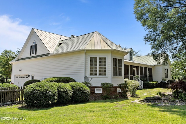 103 Low Country Ct, Hampstead, NC 28443 - view of property exterior with a sunroom, a standing seam roof, an attached garage, and metal roof