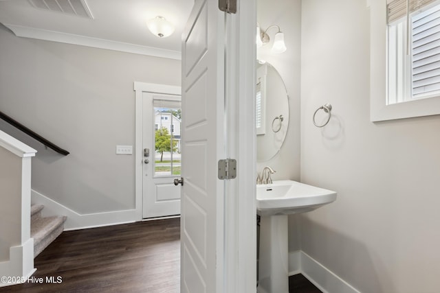 749 Cypress Village Pl, Wilmington, NC 28412 - bathroom featuring wood finished floors, a sink, ornamental molding, and baseboards