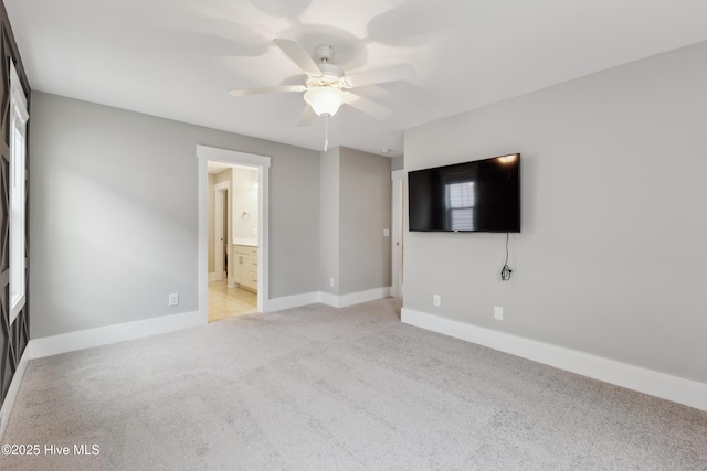 749 Cypress Village Pl, Wilmington, NC 28412 - unfurnished bedroom featuring light colored carpet, baseboards, a ceiling fan, and connected bathroom
