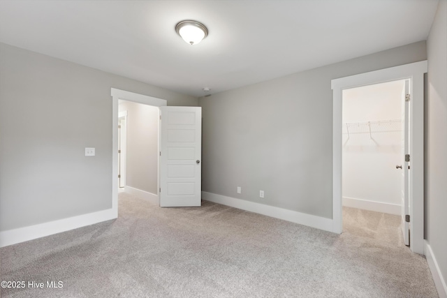 749 Cypress Village Pl, Wilmington, NC 28412 - unfurnished bedroom featuring light colored carpet, a spacious closet, baseboards, and a closet