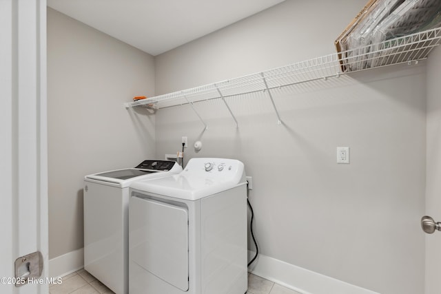749 Cypress Village Pl, Wilmington, NC 28412 - laundry area featuring washing machine and dryer, light tile patterned flooring, and baseboards