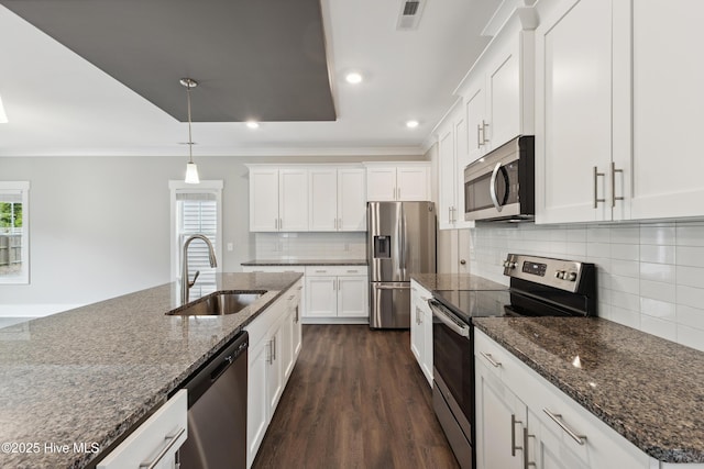 749 Cypress Village Pl, Wilmington, NC 28412 - kitchen featuring stainless steel appliances, a sink, crown molding, white cabinetry, and dark wood-type flooring