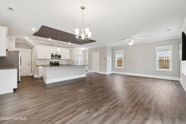 749 Cypress Village Pl, Wilmington, NC 28412 - kitchen with appliances with stainless steel finishes, crown molding, ceiling fan, dark countertops, and open floor plan