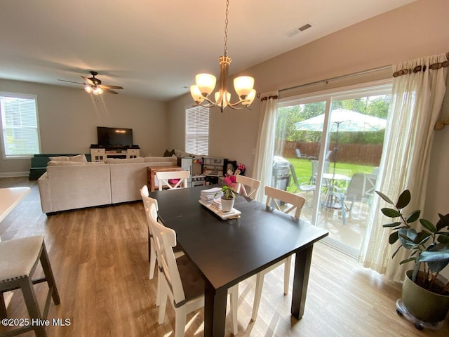 4224 Pegasus Pkwy, Leland, NC 28451 - dining room featuring wood finished floors, a chandelier, a ceiling fan, and baseboards