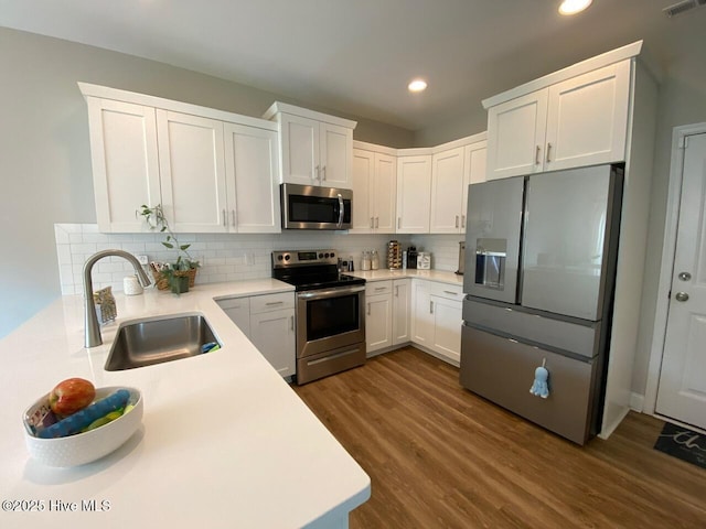 4224 Pegasus Pkwy, Leland, NC 28451 - kitchen with stainless steel appliances, a sink, recessed lighting, backsplash, and dark wood-type flooring