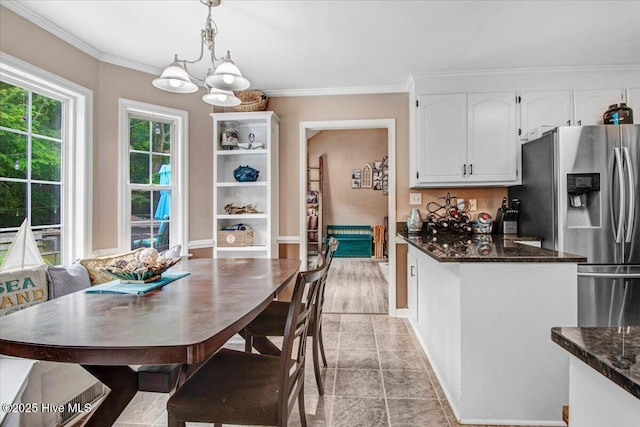 208 N Woodridge Dr, Pikeville, NC 27863 - dining space with a chandelier, crown molding, and baseboards