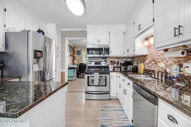 208 N Woodridge Dr, Pikeville, NC 27863 - kitchen with stainless steel appliances, a sink, white cabinets, dark stone counters, and tasteful backsplash