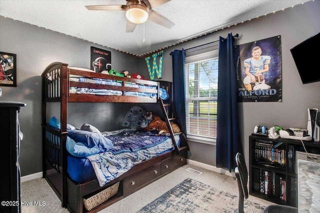 208 N Woodridge Dr, Pikeville, NC 27863 - bedroom featuring a textured ceiling, baseboards, carpet flooring, and a ceiling fan