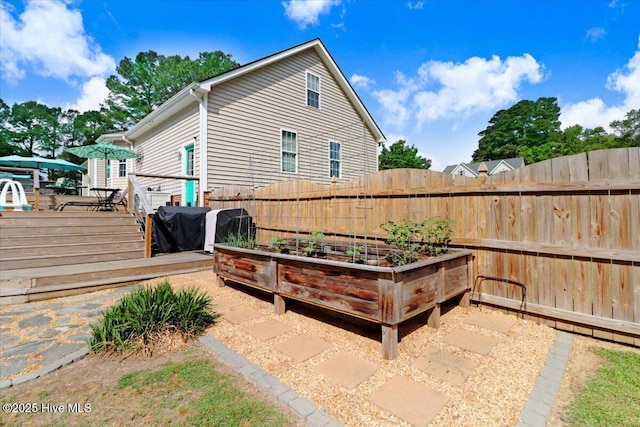 208 N Woodridge Dr, Pikeville, NC 27863 - view of patio / terrace featuring a wooden deck and a vegetable garden