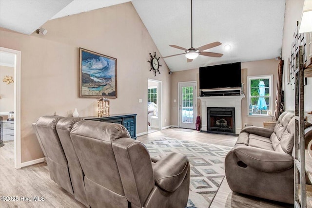 208 N Woodridge Dr, Pikeville, NC 27863 - living area featuring a ceiling fan, light wood-style floors, plenty of natural light, a fireplace, and high vaulted ceiling