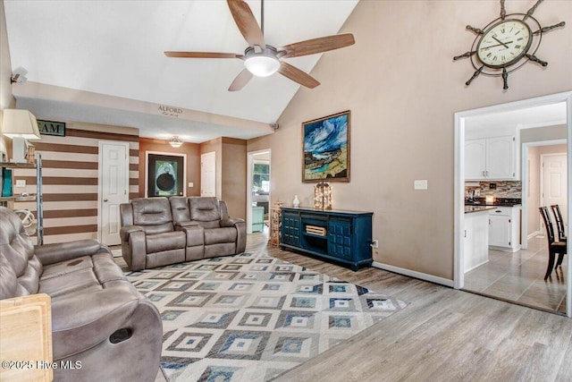 208 N Woodridge Dr, Pikeville, NC 27863 - living area with high vaulted ceiling, light wood-style floors, ceiling fan, and baseboards