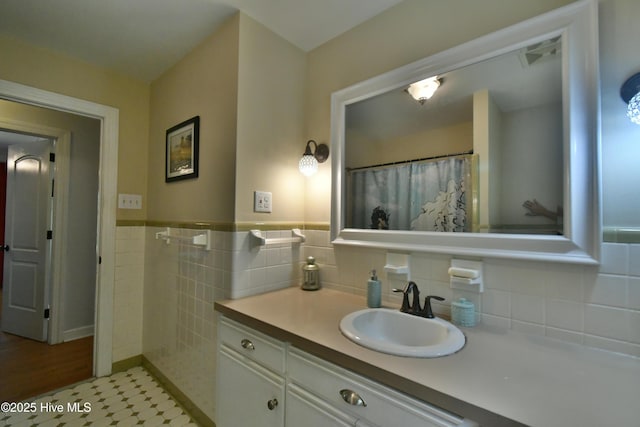114 Lansdowne Rd, Wilmington, NC 28409 - full bathroom featuring vanity, tile walls, and a wainscoted wall