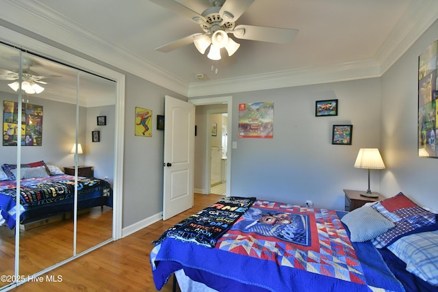 114 Lansdowne Rd, Wilmington, NC 28409 - bedroom with wood finished floors, a ceiling fan, crown molding, a closet, and baseboards