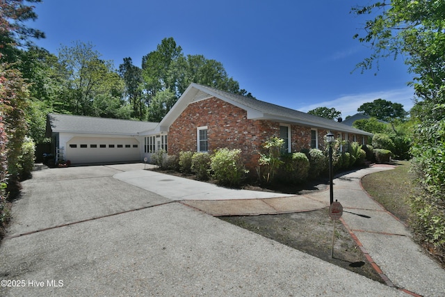 114 Lansdowne Rd, Wilmington, NC 28409 - view of side of property with concrete driveway, brick siding, and a garage