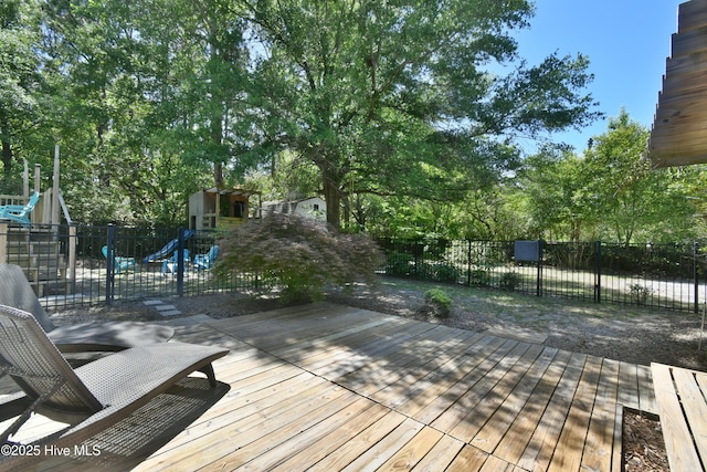 114 Lansdowne Rd, Wilmington, NC 28409 - wooden terrace with a playground and view of wooded area