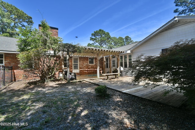 114 Lansdowne Rd, Wilmington, NC 28409 - rear view of property featuring a pergola, a chimney, brick siding, and a patio area