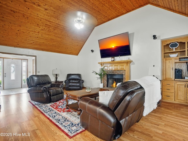 145 N Point Blvd, Moyock, NC 27958 - living room with lofted ceiling, light wood-style flooring, wood ceiling, and a brick fireplace
