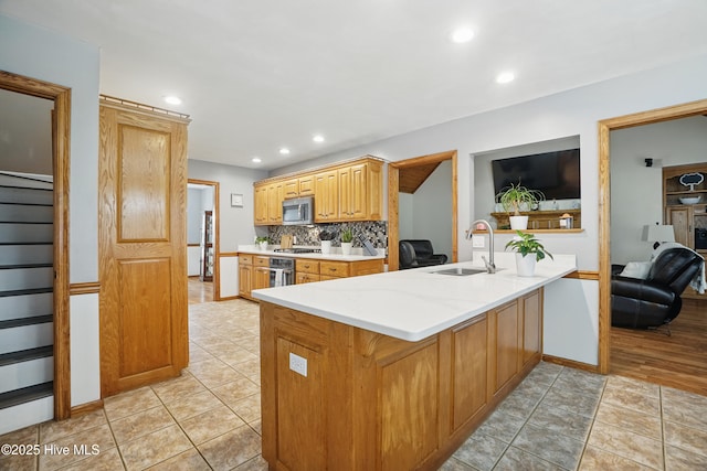 145 N Point Blvd, Moyock, NC 27958 - kitchen with a sink, stainless steel microwave, recessed lighting, decorative backsplash, and baseboards