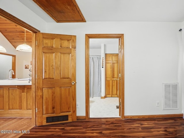 145 N Point Blvd, Moyock, NC 27958 - unfurnished bedroom with ensuite bath, wood finished floors, a sink, and baseboards