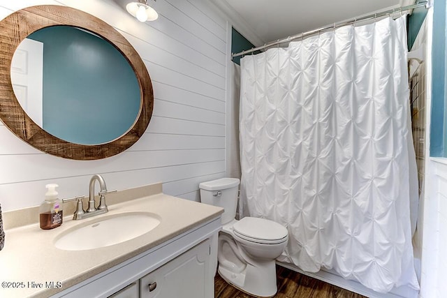 4838 Stillwell Rd, Wilmington, NC 28412 - full bath featuring vanity, toilet, wood finished floors, wood walls, and a shower with shower curtain