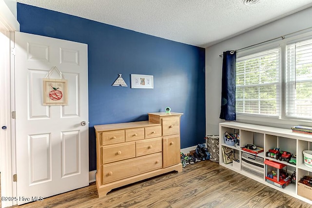 4838 Stillwell Rd, Wilmington, NC 28412 - game room with a textured ceiling and wood finished floors