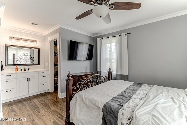 4838 Stillwell Rd, Wilmington, NC 28412 - bedroom featuring wood finished floors, crown molding, a spacious closet, ceiling fan, and a closet