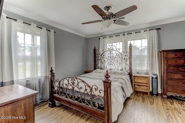 4838 Stillwell Rd, Wilmington, NC 28412 - bedroom with multiple windows, ornamental molding, wood finished floors, and a ceiling fan