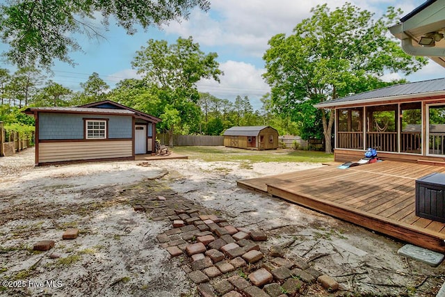 4838 Stillwell Rd, Wilmington, NC 28412 - fenced backyard with a wooden deck and a sunroom