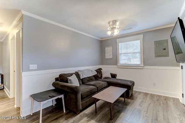 4838 Stillwell Rd, Wilmington, NC 28412 - living area featuring wainscoting, ornamental molding, wood finished floors, a ceiling fan, and electric panel