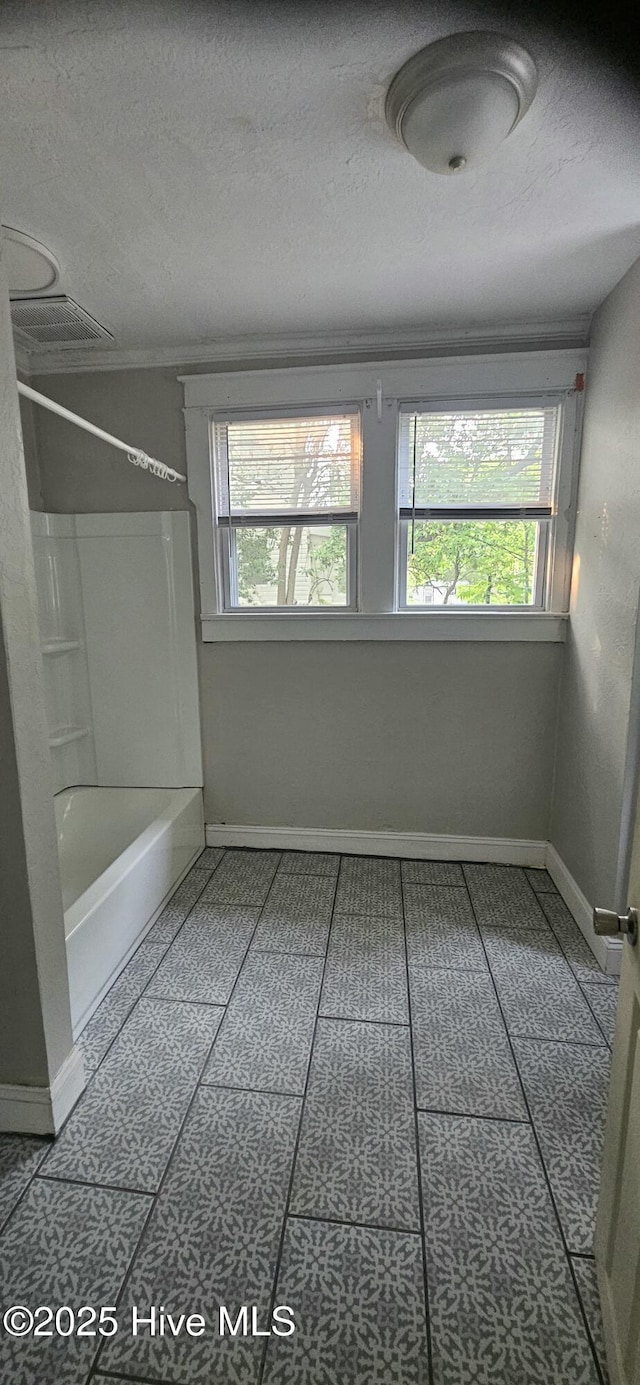 1205 S 7th St, Wilmington, NC 28401 - full bathroom featuring baseboards, bathing tub / shower combination, and a textured ceiling