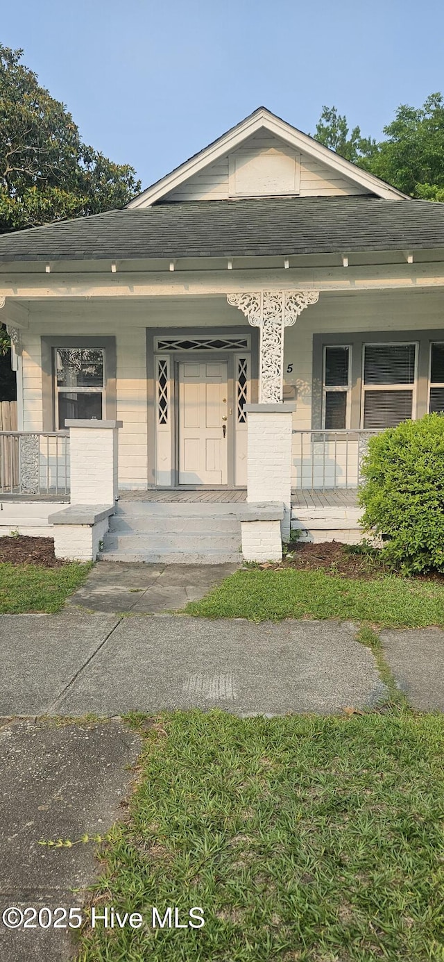 1205 S 7th St, Wilmington, NC 28401 - shotgun-style home with a porch and roof with shingles