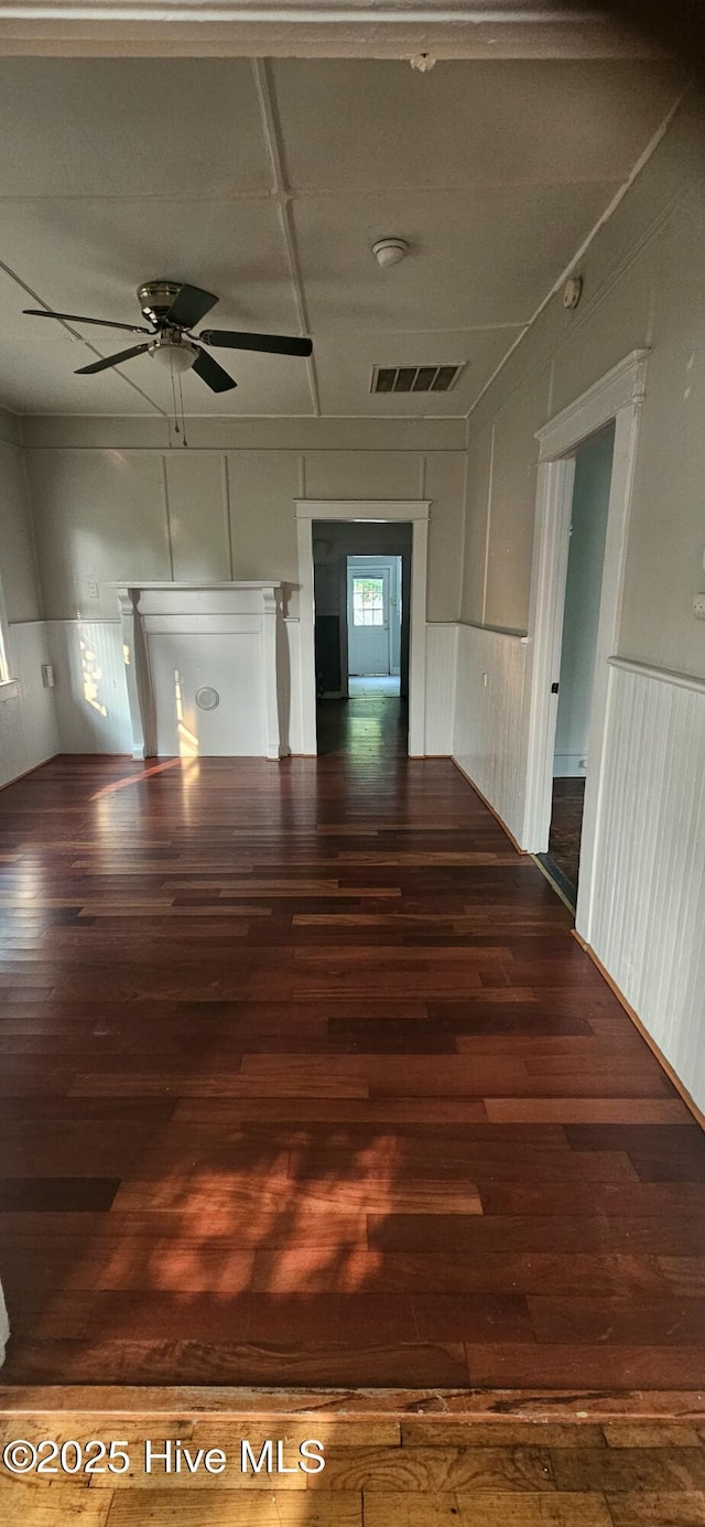 1205 S 7th St, Wilmington, NC 28401 - spare room with wood finished floors, ceiling fan, a decorative wall, and a wainscoted wall