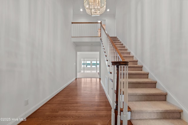 151 Pungo View Rd, Belhaven, NC 27810 - stairs featuring wood finished floors, baseboards, a towering ceiling, a chandelier, and recessed lighting