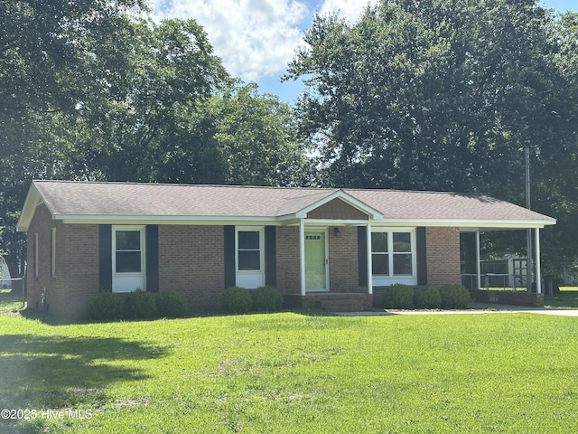 103 Pate Cir, Goldsboro, NC 27530 - ranch-style house with a front yard and brick siding