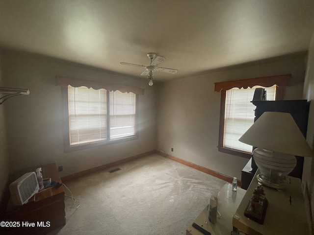 5011 Community Grocery Rd, Wilson, NC 27893 - unfurnished bedroom with multiple windows, carpet flooring, baseboards, and ceiling fan