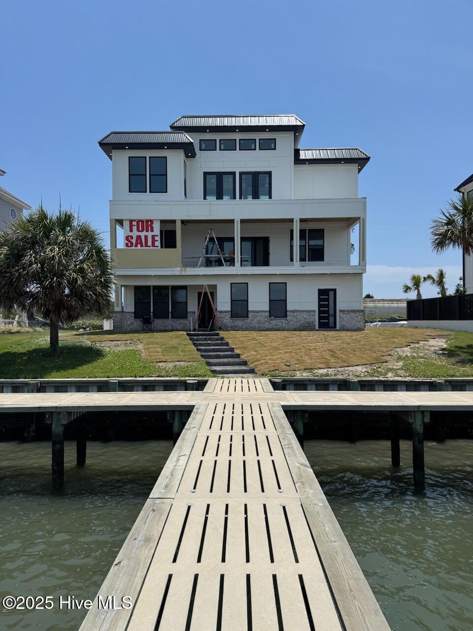 208 Radio Island Rd, Morehead City, NC 28557 - dock area with a water view, a balcony, stairs, and a yard