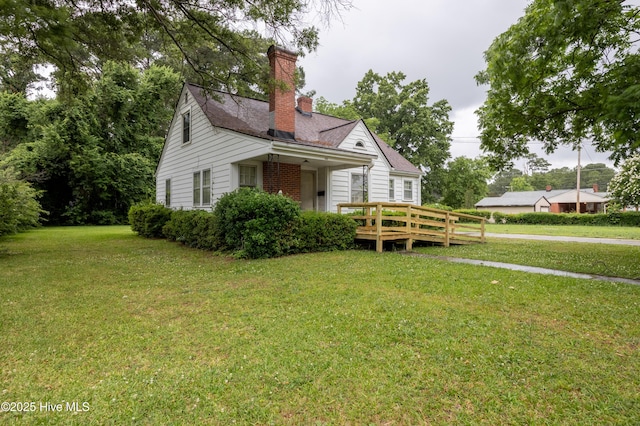 108 Stadium St SW, Wilson, NC 27893 - view of side of property with a yard, a wooden deck, and a chimney