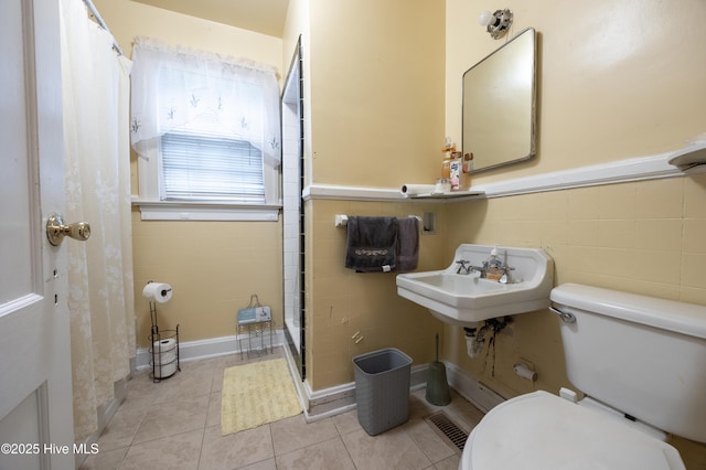 108 Stadium St SW, Wilson, NC 27893 - full bath with a shower stall, tile patterned floors, and wainscoting
