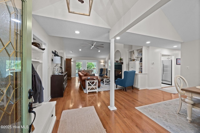 112 Lakeview Ln, Washington, NC 27889 - living area with vaulted ceiling, a warm lit fireplace, a ceiling fan, light wood-style flooring, and recessed lighting