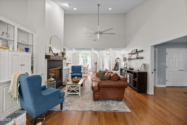 112 Lakeview Ln, Washington, NC 27889 - living area featuring wood finished floors, a towering ceiling, ceiling fan, a glass covered fireplace, and recessed lighting
