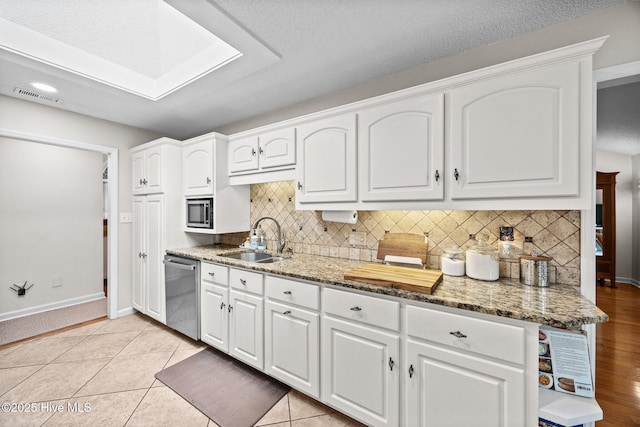 112 Lakeview Ln, Washington, NC 27889 - kitchen featuring appliances with stainless steel finishes, light stone counters, white cabinets, and recessed lighting
