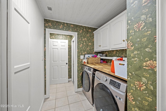 112 Lakeview Ln, Washington, NC 27889 - washroom with separate washer and dryer, wallpapered walls, light tile patterned flooring, and cabinet space