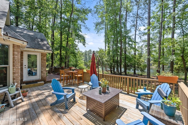 112 Lakeview Ln, Washington, NC 27889 - wooden deck with outdoor dining area and view of wooded area