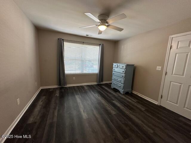 5610 Carolina Beach Rd Unit 6, Wilmington, NC 28412 - unfurnished bedroom featuring dark wood-style floors, baseboards, and a ceiling fan