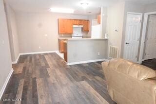 5610 Carolina Beach Rd Unit 6, Wilmington, NC 28412 - kitchen featuring baseboards, dark wood finished floors, a peninsula, and brown cabinets